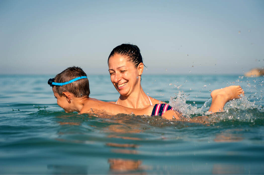 Woman helping her child swim